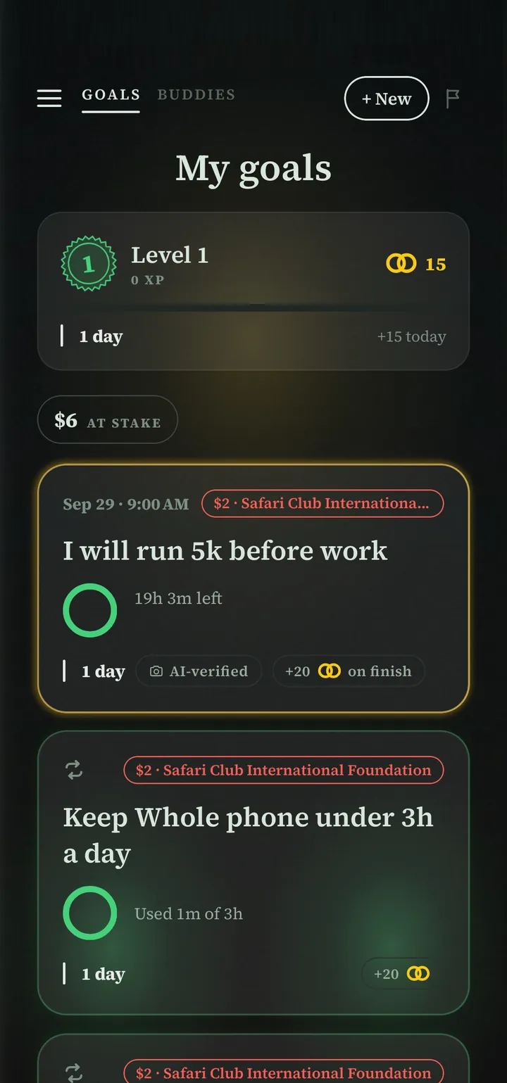 The Punish home screen. $6 at stake across three goals: I will run 5k before work, checked by an AI-verified photo tomorrow at 9 AM; Keep whole phone under 3h a day, used 1 minute; each card shows $2 going to Safari Club International Foundation if it is missed.